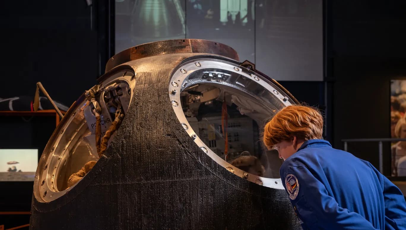 boy looking at astronaut exposition