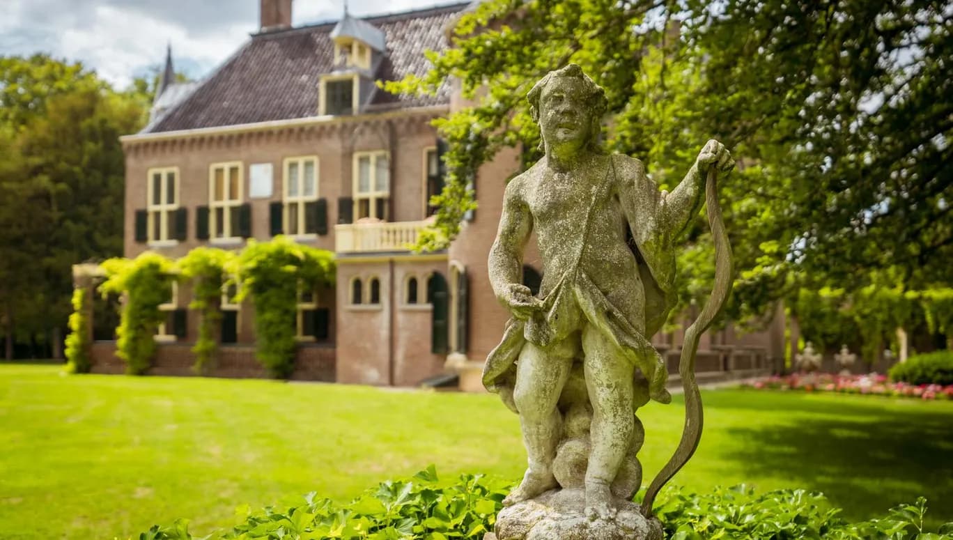 Statue of Cupid in the garden of Keukenhof Castle.