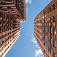 Zuidas architecture, tall building under a blue sky.