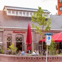 People sitting Outside Poesiat en Kater Oost