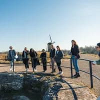 A group of people taking a tour of the Fort van Hoofddorp