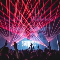People dancing under the red laserlights.