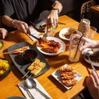 AMOI Asian restaurant, group eating food, rice and dumplings