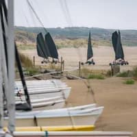 Boats in the sand and blowcarters at IJmuiderslag beach.