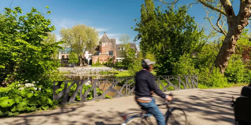 A person cycles through Oosterpark.