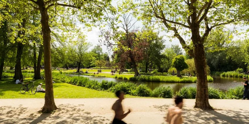 Joggers running through Vondelpark.