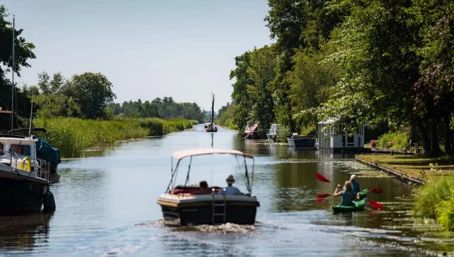 A boat passing trough the water of the Groene Hart.