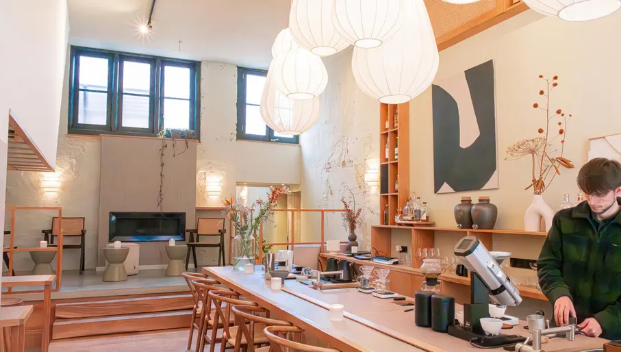 Barista making coffee in the interior of Taru Japanese/Scandinavian coffee shop and cocktail bar. Haarlem Content Creation Day March 2024