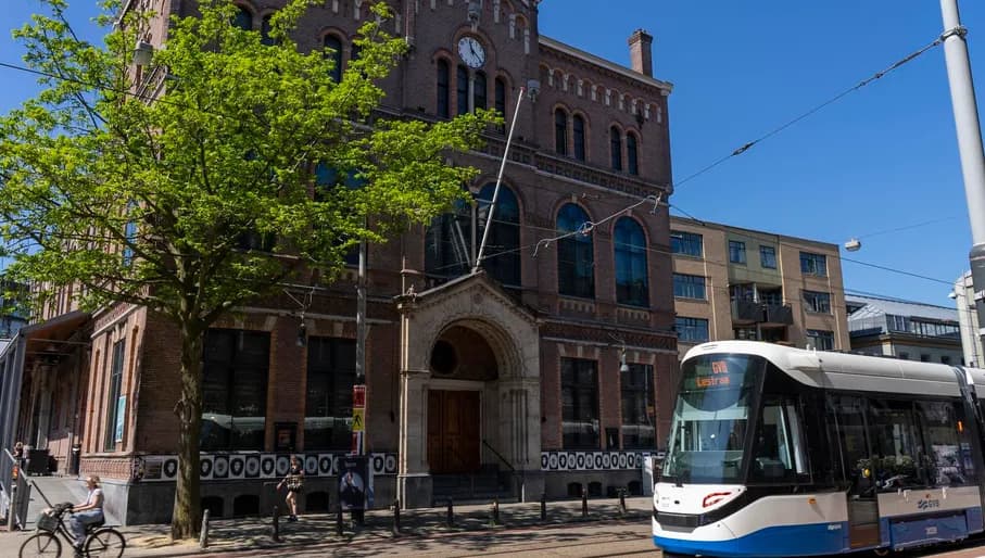 A tram passing music venue Paradiso at Weteringschans near Leidseplein.