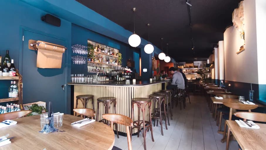 People sitting at the bar Inside Sjefietshe seafood restaurant