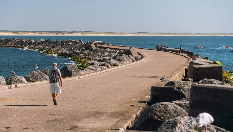 A man walking over Zuidpier IJmuiden.