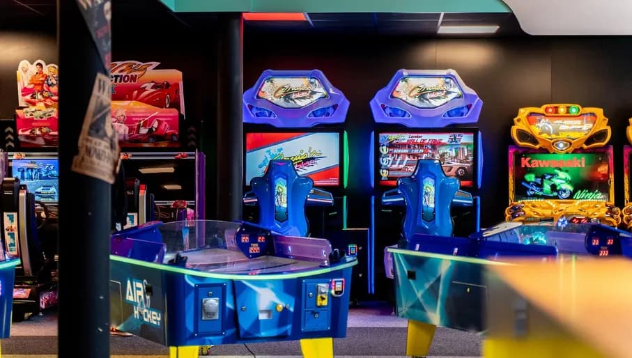 Arcade with anime interior, design and toys and gifts. Arcade machines and air hockey, racing games, colorful