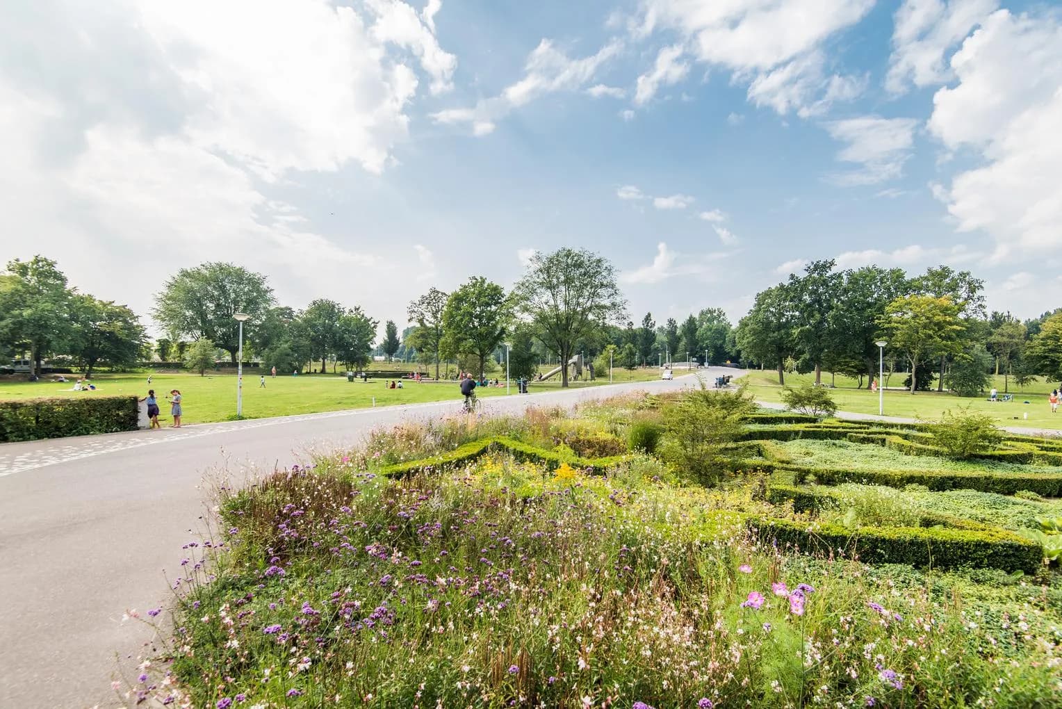 Noorderpark cycle path with gardens and flowers in summer