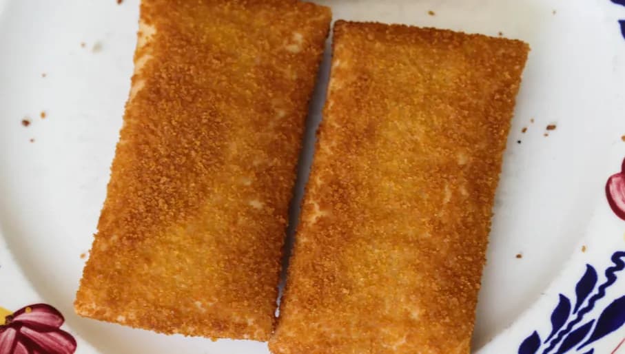 Close up of kaassoufflé, a Dutch snack of melted cheese inside a thin dough-based wrap